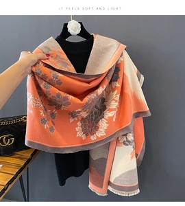 Detail showing the floral pattern and soft texture of an orange and beige pashmina scarf