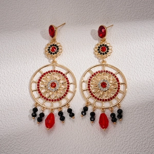 Vintage gold hollow flower earrings with red drop pendants and black bead tassels
