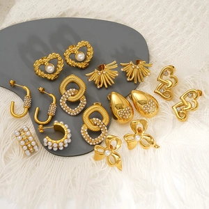 Gold-plated heart and bow earrings collection featuring white pearls and clear crystals