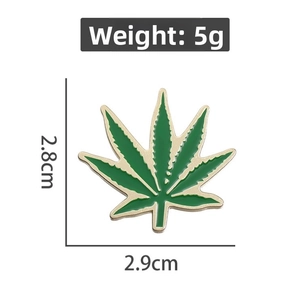 Detailed view of green cannabis leaf enamel pin with 2.8cm by 2.9cm dimensions