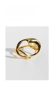 Detail view of gold twisted ring featuring a modern minimalist abstract flowing design