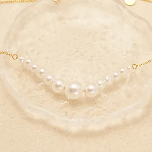 Elegant 18K gold plated necklace featuring 13 gradient white pearls on a fine chain
