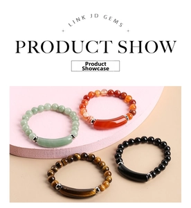 Set of natural stone bracelets with rose quartz, tiger eye and aventurine on pink podium