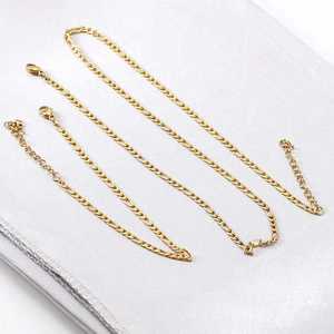 Detailed view of 18K gold plated stainless steel Figaro chain necklace and bracelet set