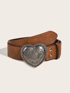 Detail of a brown leather belt featuring paisley embossing and a silver heart-shaped buckle