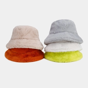Detail of plush bucket hats in multiple colors showing soft faux fur texture and fabric quality