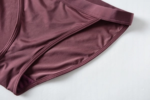 Detailed view of stitching and texture on dark purple low-rise ice silk briefs