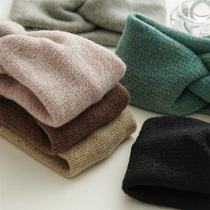 Close-up of chunky knit headbands showing soft texture and stylish cross knot details
