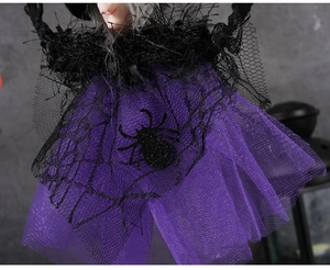 Macro shot of purple mesh skirt with cobweb patterns and glitter spider for Halloween