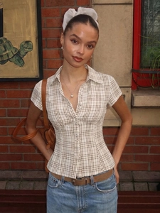 French style plaid short sleeve shirt in beige and brown with retro brick background