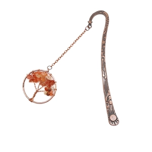 Detail of bronze tree of life bookmark with orange crystal stones and sun engraving