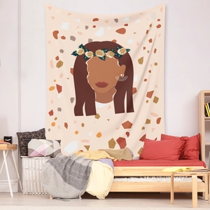 Detail of bohemian tapestry featuring floral woman silhouette on cozy bedroom wall