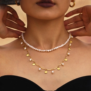 Double-layered gold necklace with freshwater pearls and a shell pendant for women