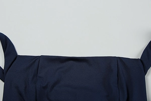 Detail of navy blue summer dress showing high-quality stitching and neckline fabric texture