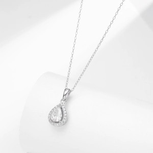 Detail view of silver necklace featuring a pear-cut zircon pendant with micro-pave halo