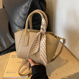 Chic lychee pattern bucket bag in khaki leather with decorative geometric silk scarf