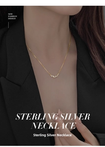Close-up of minimalist gold S925 sterling silver smile necklace with sparkling zircons