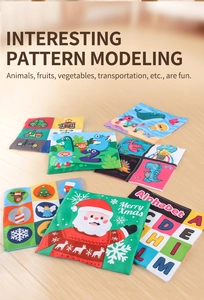 Detailed set of six soft educational cloth books for babies on a wooden floor