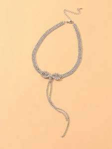 Detailed view of silver rhinestone bow necklace with elegant fringe and lobster clasp closure
