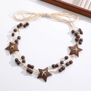Detail of woven rope belt with coffee wood beads and natural five-point star charms