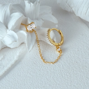 Detail of S925 sterling silver chain earrings with heart zircon and gold plating finish