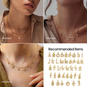 Macro detail of gold-plated cubic zirconia letters and numbers charms for jewelry DIY