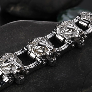 Macro detail of polished stainless steel lion head links on a heavy biker chain bracelet