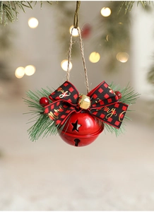Detail of red Christmas bell with buffalo plaid bow and Merry gold text on festive tree