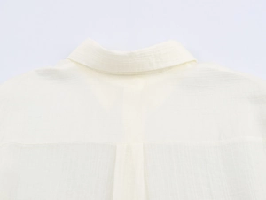 Close-up detail of the white textured fabric collar on this minimalist casual shirt