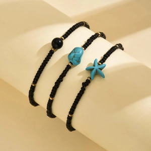 Detail of bohemian starfish anklet set with turquoise stones and black seed beads