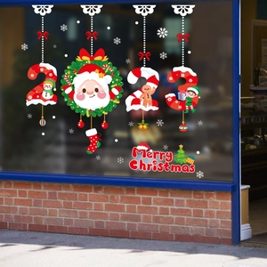 Close-up of 2023 Merry Christmas window decals with Santa and snowman on glass