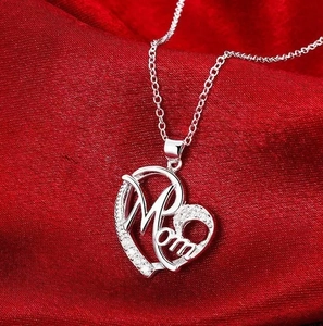 Silver heart necklace with Mom engraving and zircons on elegant red silk backdrop