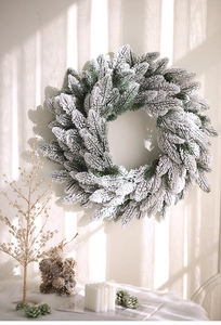 Detail of a large frosted PE Christmas wreath with realistic pine needles and flocked snow