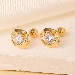 Golden rose stud earring with sparkling zircon on natural stone and silk backdrop