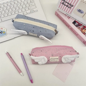 Close-up of star pattern stationery bags with plush wings in blue and pink colors