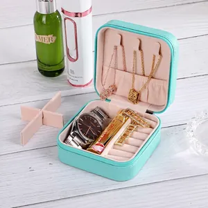 Portable mint green leather jewelry box with zipper and plush pink velvet lining