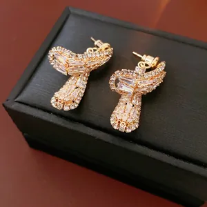Bowtie drop earrings with sparkling cubic zirconia on a luxury gold base setting