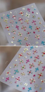 Macro detail of 3D embossed retro cross nail stickers with gold edges and gems