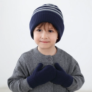 Kids navy blue striped knit hat and warm mittens set shown on a young child model