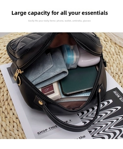 Interior view of black quilted chain bag showing ample storage for phone and wallet