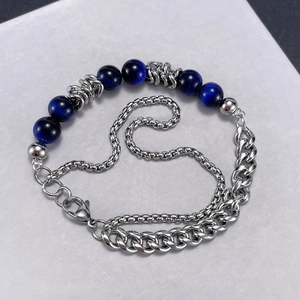 Double-layered stainless steel chain bracelet with deep blue tiger eye beads on textured stone