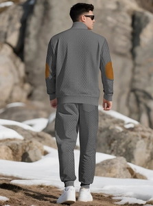 Men's grey waffle-knit tracksuit with brown elbow patches and athletic fit shown from behind