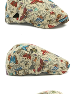 Detail of beige jacquard flat cap with colorful butterfly embroidery and metal buckle