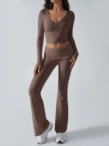 Detail of a brown ribbed V-neck long sleeve top and matching flared trousers set