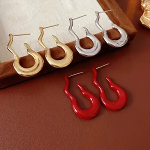 Artistic curved teardrop stud earrings in gold, silver, and glossy red lacquer finish