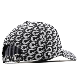 Detail view of monochrome geometric pattern baseball cap with silver metal buckle closure