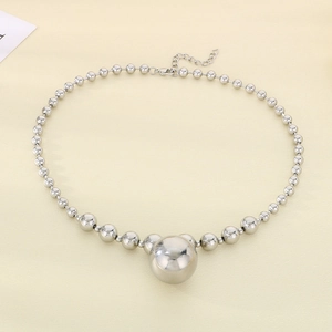 Detail of silver beaded necklace featuring a central spherical pendant and lobster clasp