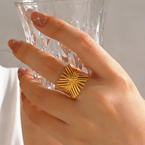 Minimalist 18K gold plated geometric ring in a chunky bold design worn by a female model