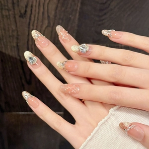 Nude pink gradient press-on nails with gold glitter and luxury pearl diamond accents