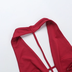 Macro shot of precise stitching and durable elastic fabric on deep red halter jumpsuit